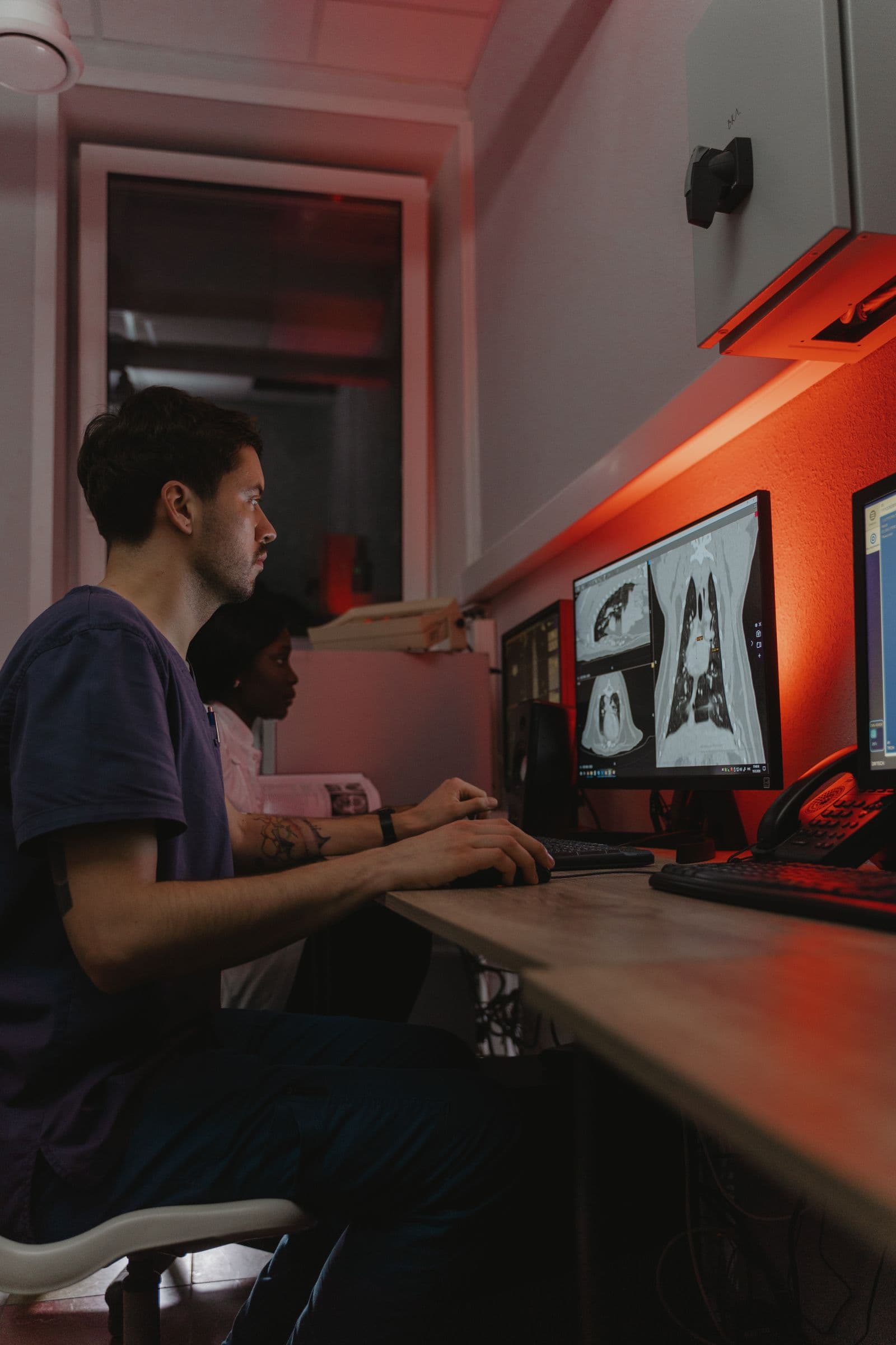Clinicians reviewing diagnostic images together on a computer